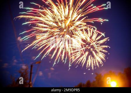 Colorful fireworks on the night sky. Explosions of pyrotechnics at the festival Stock Photo