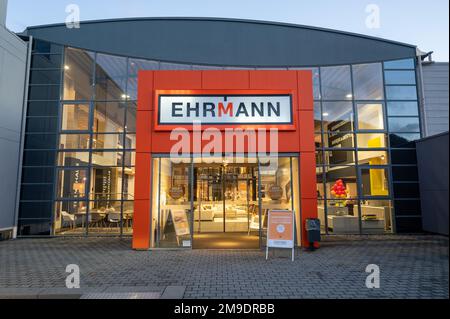 Trier, Germany. 11th Jan, 2023. Company boss Horst Ehrmann (l) stands at the entrance to the Ehrmann furniture store in Trier with store manager Stefan Grotelüschen. There are signs on the door