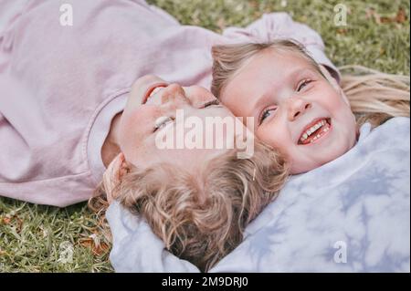 My sister, my favourite friend in the world. two adorable little girls having fun in a garden. Stock Photo
