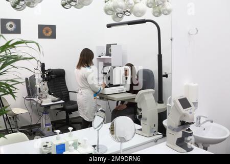 Eyeglasses selection on modern diagnostic equipment in an ophthalmic clinic. Modern diagnostic equipment in ophthalmic clinic Stock Photo