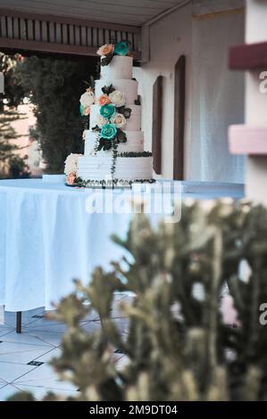 white and red roses with cut cake on wedding reception Stock Photo