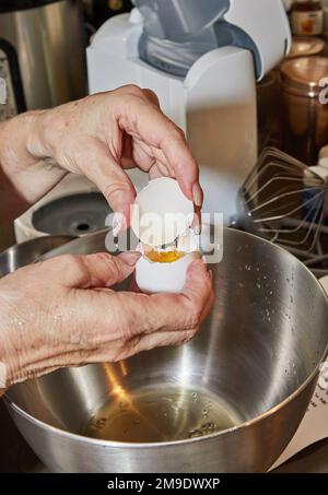 Chef separates the yolk from the protein to make the pie. Stock Photo