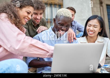 group of students watching a fun video on a laptop. close-up. Stock Photo
