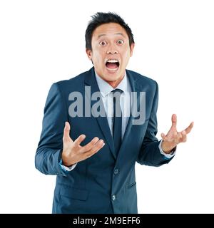 Angry, frustrated and portrait of a surprised Asian man isolated on a white background in a studio. Shocked, unhappy and amazed Japanese businessman Stock Photo