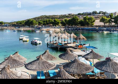 Ksamil, Albania - September 11, 2021: Poda Beach at Ksamil, Albania, has a few people relaxing there. Vacation concept background. Stock Photo