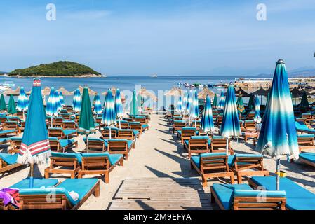 Ksamil, Albania - September 11, 2021: Few people relaxing on the Poda Beach in Ksamil, Albania. Vacation concept background. Stock Photo