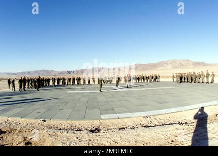 Straight on long shot with a wide angle, fish-eye lens at US Marines standing in formation on the Helicopter landing pad at Camp Wilson, Twentynine Palms Marine Corps Air-Ground Combat Center, California, during a celebration of the Marine Corps' 224th Birthday. The permanently and temporarily assigned Marines are taking part in Cax 2 (Combined Arms Exercise). Subject Operation/Series: CAX 2 Base: Camp Wilson, Twentynine Palms State: California (CA) Country: United States Of America (USA) Stock Photo