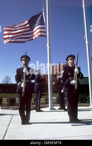 US Air Force Technical Sergeant Kristofer Gacono (left) and STAFF Sergeant Mike Weaver, stand guard as the flag is lowered during a Retreat ceremony honoring the Tuskegee Airmen on Veterans Day. Pennsylvania State University, Harrisburg, hosted this event and the Honor Guard, from the 193rd Specials Operations Wing, Pennsylvania Air National Guard, Middletown, PA, performed the retreat ceremony. Base: Harrisburg State: Pennsylvania (PA) Country: United States Of America (USA) Stock Photo