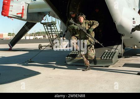 Right side rear view medium shot of US Marines from Bravo Company, 8th Marine Regiment, 1ST Battalion, 2nd Marine Division, as they disembark from the rear entrance of a Marine MV-22 Osprey on the flight line of Marine Corps Air Station New River, Jacksonville, North Carolina. Base: Mcas, New River State: North Carolina (NC) Country: United States Of America (USA) Stock Photo