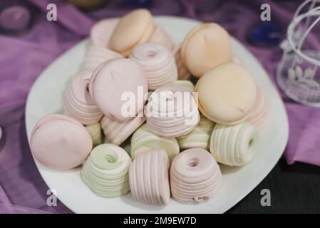 colorful delicate pastel marshmallows and macaroons on a plate Stock Photo