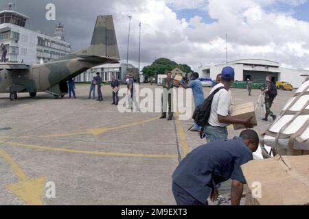 A straight on medium shot as a South African aircrew and local laborers load a South African Air Force aircraft, with humanitarian relief supplies destined for Beira, Mozambique, at the International Airport at Maputo, Mozambique, Africa on 16 March 2000. The South African Air Force along with several other nations (not shown) from around the world are in Maputo, to help the people of Mozambique, after severe flooding (flooding and victims not shown) displaced over a million people from their homes. Subject Operation/Series: ATLAS RESPONSE Base: Maputo State: Inhambane Country: Mozambique (MOZ Stock Photo