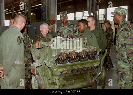 During his final visit to Fort Hood, Texas, prior to his planned retirement early this Summer, Sergeant Major of the Army, Robert E. Hall (4th from left), talks with Soldiers of the 190th Maintanence, 13th Corps Support Command (COSCOM), as they perform heavy engine repair on April 18th, 2000. Base: Fort Hood State: Texas (TX) Country: United States Of America (USA) Stock Photo