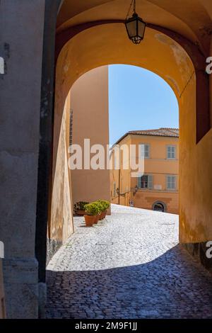 View through archway onto Piazza della Liberta, Castel Gandolfo, Lazio, Italy Stock Photo