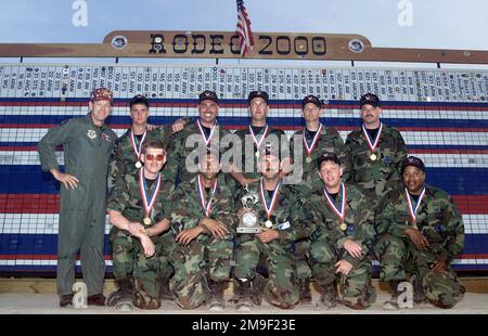 Straight on medium shot as US Air Force members from the 605 Aircraft Generation Squadron, McGuire AFB, New Jersey, pose for a picture at the awards ceremony after winning the KC-10 Extender pre-flight event (KC-10 not shown) on May 11, 2000 during the Rodeo 2000 readiness competition at Pope AFB. During the one week competition, more than 100 teams and 2,500 personnel from over 300 Air Force, Air Force Reserve, Air National Guard, U.S. Army units, and foreign nations will compete in airdrops, cargo loading, refueling, pre-flight, combat endurance, combat tactics, as well as other air and grou Stock Photo