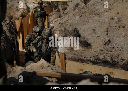 German soldiers assigned to the 212th Panzergrenadier Battalion, 21st Panzer Brigade, 1st Panzer Division, clear a trench during a live-fire exercise as part of Defender Europe at Oberlausitz Training Area, Germany, May 19, 2022. Defender Europe 22 is a series of U.S. Army Europe and Africa multinational training exercises in Eastern Europe. The exercise demonstrates U.S. Army Europe and Africa’s ability to conduct large-scale ground combat operations across multiple theaters supporting NATO. Stock Photo