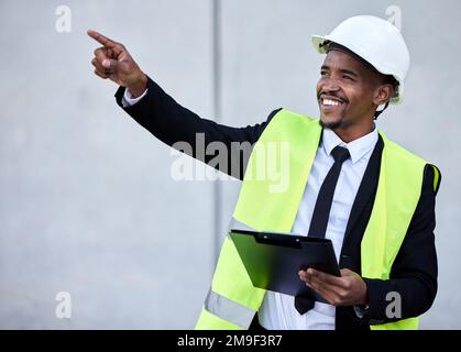 Ill check that next. a young male construction worker working on site. Stock Photo