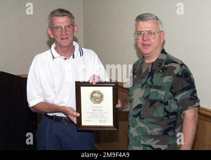 Lieutenant Colonel Dolas Bain presents Robert Brock with an award for 40 years of government service. Base: Fort Dix State: New Jersey (NJ) Country: United States Of America (USA) Stock Photo