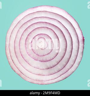 A slice of red onion isolated on blue background Stock Photo