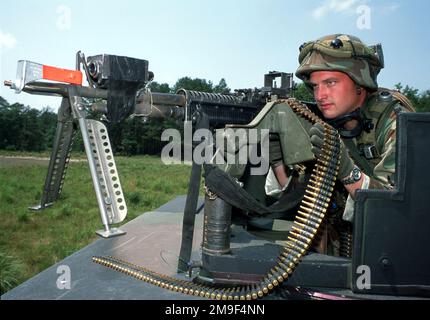 Left side front view medium close-up of USAF AIRMAN Cory Best, 305th Security Forces Squadron, McGuire Air Force Base, New Jersey, as he mans a M60 Machine Gun from the top turret of a High-Mobility Multipurpose Wheeled Vehicle (HMMWV). The machine gun and AMN Best are equipped with Multiple Integrated Laser Engagement System (MILES) gear. He is part of a group of 220 Air Force members participating in Phoenix Readiness at Fort Dix, New Jersey. (Duplicate image, see also DF-SD-01-01617 or search 000626-F-0007M-005). Subject Operation/Series: PHOENIX READINESS COURSE Base: Mcguire Air Force Bas Stock Photo