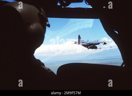 An aerial view of a US Air Force MC-130P Combat Shadow aircraft refueling a MH-60G Pave Hawk helicopter. The photo was taken from inside the cockpit and over the pilots shoulder of an unidentified aircraft. From AIRMAN Magazine, July 2000 article 'Front Cover.'. An aerial view of a US Air Force MC-130P Combat Shadow aircraft refueling a MH-60G Pave Hawk helicopter. The photo was taken from inside the cockpit and over the pilotÕs shoulder of an unidentified aircraft. From Airman Magazine, July 2000 article 'Front Cover.' Stock Photo