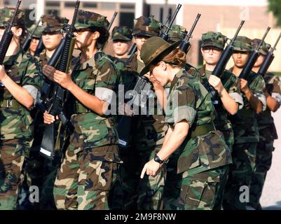 US Marine Platoon 4033 practices close order drill as 4th Battalion Drill Instructor STAFF Sergeant Love (Right, pointing down) monitors their effort. The female recruits are practicing on the 4th Battalion Parade Deck, Marine Corps Recruit Depot, Parris Island, South Carolina, on August 22nd, 2000. Base: Usmc Recruit Depot,Parris Island State: South Carolina (SC) Country: United States Of America (USA) Stock Photo