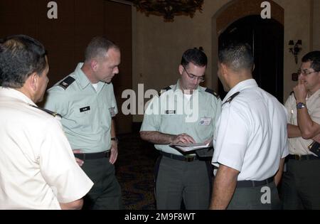 Colonel (COL) Julius E. Clark, US Army South Deputy CHIEF of STAFF for Operations, and Co-Director for Peace Keeping Operations North-2000, (second from left), gets a briefing from Major Eric Stewart, DCSOPS Exercise Division, (center), about the closing ceremony plans at the Hotel Princess in Tegucigalpa, Honduras. Looking on are Honduran COL Jorge Andino, exercise Co-Director, left; Lieutenant Colonel Heriberto Garcia, DCSOPS Exercise Division Director, (second from right); and Honduran COL Willy Nelson Mejia, After-Action Review Co-Director, (right). The exercise, which is being held on 14- Stock Photo