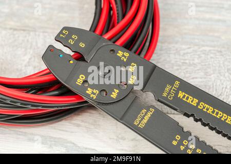 Chinese made unbranded wire stripper & wire cutter for 26-10AWG wire (see Notes) with coiled connector cables. Stock Photo