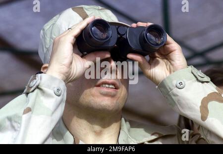 Mr. Richard Jones, United States Ambassador to Kazakhstan, watches through binoculars for members of the 82nd Airborne Division (not shown), deployed from Fort Bragg, North Carolina, during an international mass jump into Kazakhstan. Paratroopers from Kazakhstan, the United States and Turkey are descending into Kazakhstan to prepare for the the start of CENTRASBAT 2000. The Central Asian Peacekeeping Battalion exercise CENTRASBAT 2000 is a multi-national peacekeeping and humanitarian relief exercise sponsored by U.S. CENTCOM and hosted by the former the Soviet Republic Kazakhstan in Central As Stock Photo