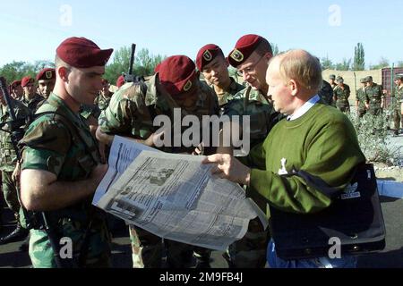 Members of the U.S. Army's 82nd Airborne Division, deployed from Fort Bragg North Carolina, check out their photos published in a Kazakhstan newspaper prior to the start of CENTRASBAT (Central Asian Peacekeeping Battalion) 2000 opening ceremonies on September 13th, 2000. CENTRASBAT 2000 is a multi-national peacekeeping and humanitarian relief exercise sponsored by United States Central Command (U.S. CENTCOM) and hosted by former Soviet Republic Kazakhstan in Central Asia, Sep. 11-20, 2000. Exercise participants include approximately 300 U. S. troops including personnel from U.S. CENTCOM, from Stock Photo