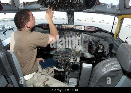 US Air Force SENIOR AIRMAN John Murphy, a Crew CHIEF from the 363rd Expeditionary Reconnaissance Squadron, Prince Sultan Air Base, Saudi Arabia, performs post-flight procedures in the cockpit of a USAF RC-135 Rivet Joint Reconnaissance aircraft at the base, on October 26th, 2000. SRA Murphy is part of the coalition force here to support Operation SOUTHERN WATCH, a military effort to enforce the no-fly and no-drive zone in Southern Iraq. Subject Operation/Series: SOUTEHRN WATCH Base: Prince Sultan Air Base Country: Saudi Arabia (SAU) Stock Photo
