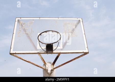 Basketball hoop on blue sky with clouds background Stock Photo