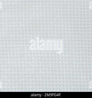 Close-up of the texture of a white cotton fabric in a cage. Stock Photo