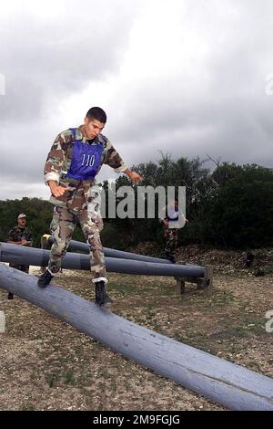 US Air Force SENIOR AIRMAN Marco Talamantez, Air Education and Training Command, carefully negotiates the Balancing Logs event, followed closely by teammate AIRMAN First Class Anthony Garcia during DEFENDER CHALLENGE 2000 at Lackland Air Force Base, Texas, on October 30th, 2000. DEFENDER CHALLENGE is the annual Air Force wide competition sponsored by Air Force Security Forces. This competition showcases the talents and capabilities of 13 international Security Forces teams in seven physical fitness, base defense and policing skills over six days. Subject Operation/Series: DEFENDER CHALLENGE 20 Stock Photo