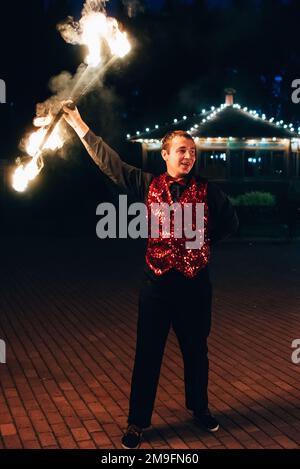 SEMIGORYE, IVANOVO OBLAST, RUSSIA - JUNE 26, 2018: Fire show. Professional male dancer fakir with a fiery sparkling torch performs Stock Photo