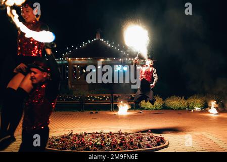 SEMIGORYE, IVANOVO OBLAST, RUSSIA - JUNE 26, 2018: Professional dancers men and women make a fire show and pyrotechnic performance at the festival wit Stock Photo