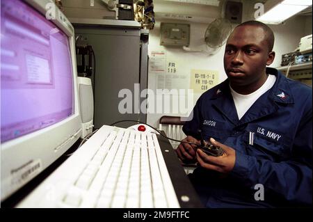 US Navy Electronics Technician Third Class performs maintenance on the ...