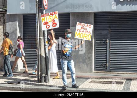 Brazilians protest carrying posters against the government of President Jair Bolsonaro in the city of Salvador, Bahia. Stock Photo