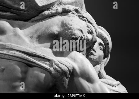 Black and white photo showing in detail the faces of stone sculptures representing Virgin Mary and dead Jesus Stock Photo