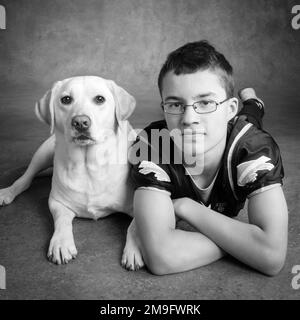 Portrait of boy with Yellow Labrador Stock Photo