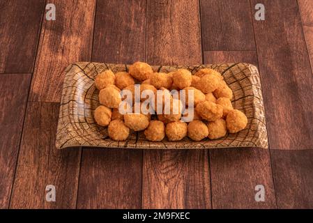 Popcorn chicken is a dish consisting of small bite-sized pieces of chicken that have been breaded and deep-fried Stock Photo