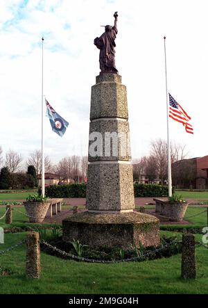 A view from behind the 48th Fighter Wing Statue of Liberty located at Royal Air Force Lakenheath, United Kingdom showing the American and British Flags being flown at half mast. The Flags were lowered to honor two US Air Force pilots who were killed in an aircraft accident. The pilots were USAF Lieutenant Colonel Ken "Buster" Hyvonen from the 48th Operational Support Squadron and USAF Captain Kirk "Jammer" Jones from the 493rd Fighter Squadron. Base: Raf Lakenheath State: East Anglia Country: England / Great Britain (ENG) Stock Photo