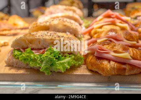 Croissant with ham, cheese and lettuce in a restaurant Stock Photo