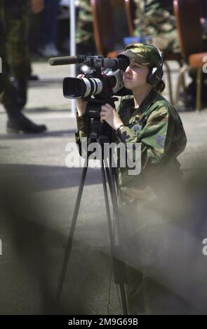 US Air Force STAFF Sergeant Angela Evans, a Videographer, assigned to US Air Forces Europe, Visual Information, documents the participants of COMBINED ENDEAVOR 2001, during the closing ceremonies on May 24, 2001. This marks the end of Combined Endeavor 2001 in Lager Aulenbach, Germany. Sponsored by US European Command and hosted by Germany, the exercise is held annually to test and document the interoperability of dozens of countires and NATO. This is the largest communications and information systems exercise in the world, 37 countries participated this year. Subject Operation/Series: COMBINE Stock Photo