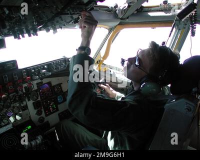 Captain (CAPT) Brad Cook, USAF, a KC-135R Stratotanker co-pilot, makes instrument adjustments during an aerial refueling mission over the Adriatic Sea. CAPT Cook deployed with about 20 other aircrew members and maintenance personnel from McConnell Air Force Base, Kansas, to the 16th Expeditionary Operations Group, a small US detachment located at Istres French air base. The McConnell active duty personnel join the primarily Air National Guard flying and maintenance operations here. The group flies aerial refueling missions in support of NATO Operation JOINT FORGE, refueling US and NATO aircraf Stock Photo