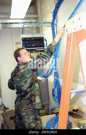 127th Communications flight personnel, Selfridge Air National Guard Base, Michigan, deployed to Elmendorf AFB Alaska, work together to install 29 miles of LAN cable to connect 250 computers to the bases computer network. In addition they will be connecting 9,500 feet of fiber optic cable to the bases existing computer network. Base: Elmendorf Air Force Base State: Alaska (AK) Country: United States Of America (USA) Stock Photo