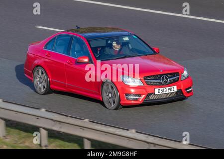 2013 Red Mercedes Benz C C250 BLUEEFFICIENCY AMG SPORT PLUS 2143 cc 7 speed manual; travelling on the M61 motorway, UK Stock Photo