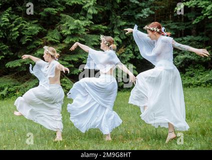 Three woman nymphs in forest, Bainbridge Island, Washington, USA Stock Photo