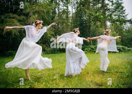 Three woman nymphs in forest,  Bainbridge Island, Washington, USA Stock Photo