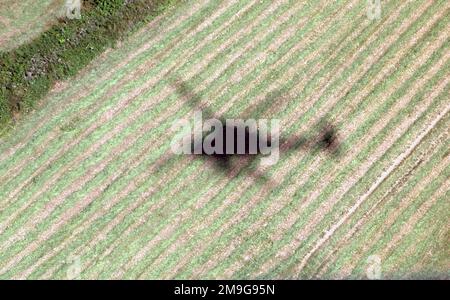 Bravo Company 5-158 Aviation Regiment UH-60 Blackhawk Helicopter casts a shadow over the Italian countryside near Aviano AB, Italy. Base: Aviano Air Base State: Pordenone Country: Italy (ITA) Stock Photo