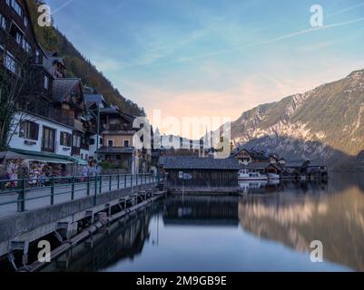 Picturesque view of the lake  Hallstatt with beautiful and colorful wooden chalet houses set on the backdrop of alpine mountains, captured at Hallstat Stock Photo